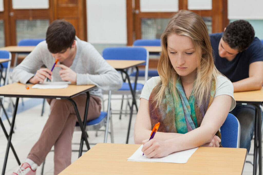 student sitting at a table for motivation letter for scholarship